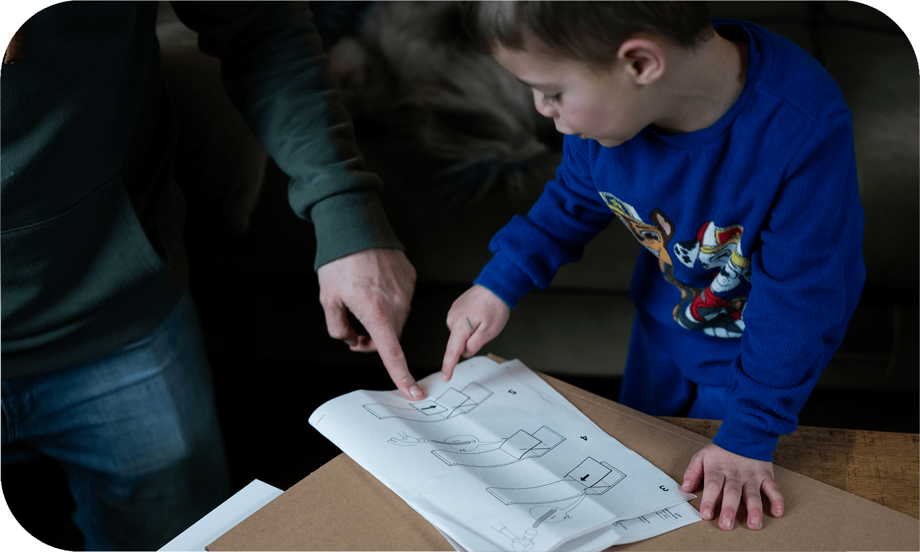 Documentaire gezinsfotografie gewoon in de woonkamer terwijl papa en zoon een kast bouwen